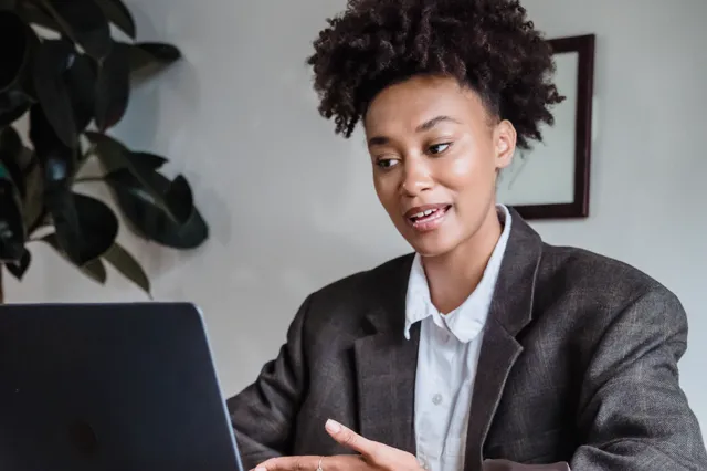 Woman working with a laptop and documents