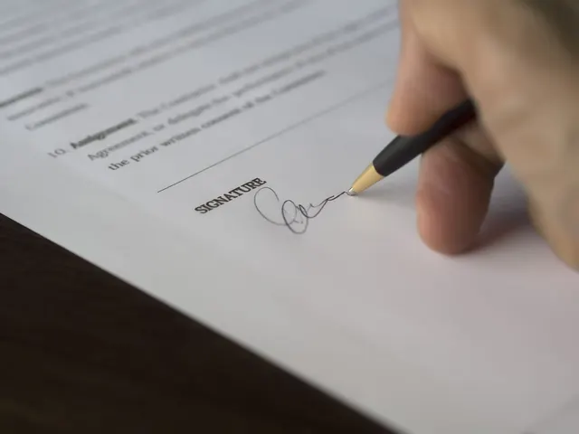 Official document with a signature line and a pen