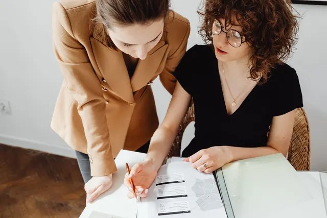 Two people reviewing paperwork at a table